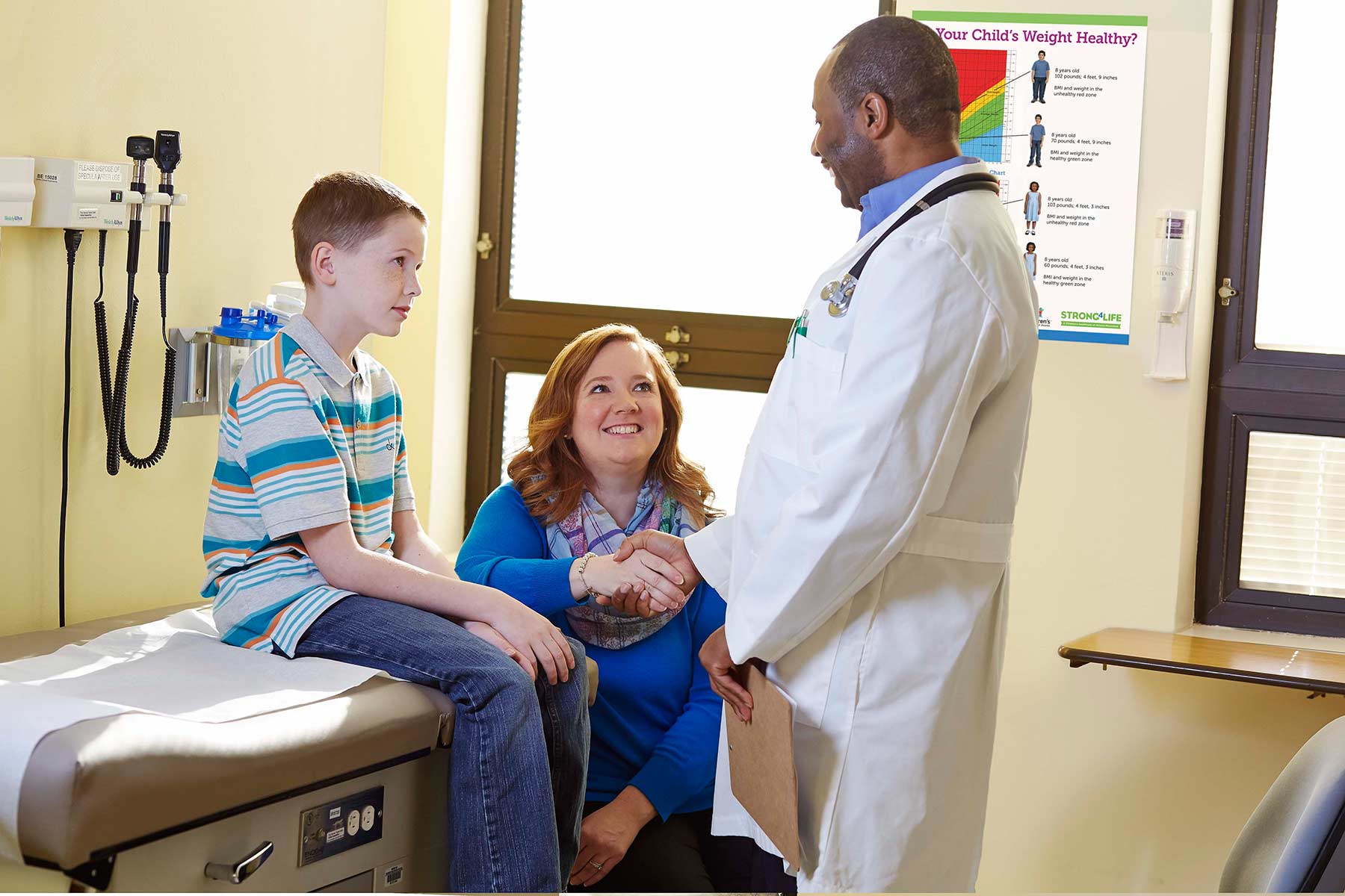 Mom and son welcoming doctor